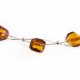 Collier d'ambre perle couleur miel sur cable acier